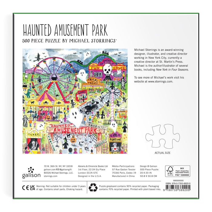 The back of the box features vibrant artwork of an amusement park with rides, ferris wheel, haunted house, and visitors. Text includes the title "Michael Storrings Haunted Amusement Park 500 Piece Puzzle" and artist info.