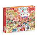 The Michael Storrings Leaf Peeping 1000 Piece Puzzle features a vibrant autumn scene with people driving, walking, and celebrating a fall festival amid colorful trees, hot air balloons, and a farm stand.
