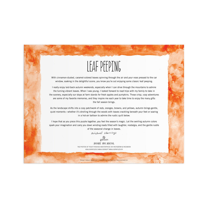 A rectangular card with an orange watercolor border and text about the Michael Storrings Leaf Peeping 1000 Piece Puzzle by Michael Storrings, celebrating fall foliage, scenic drives, and autumn adventures.