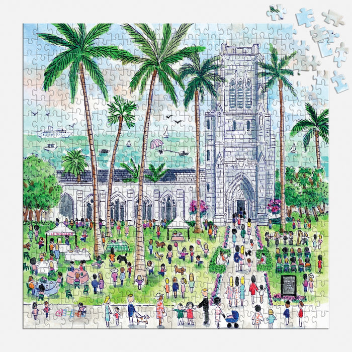 The Michael Storrings Sunday in Palm Beach 500 Piece Puzzle by Michael Storrings depicts a vibrant outdoor scene with a stone church, palm trees, people on the grass, tents, and a few unfinished puzzle pieces in the top right corner.