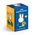 The Miffy 100 Piece Surprise Puzzle by Miffy comes in a blue and yellow box with Miffy illustrations, including holding flowers and riding a bike. Each box has one 100-piece puzzle; collect all six surprise designs!.
