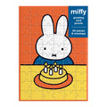 The Miffy Birthday Greeting Card Puzzle by Miffy is a 60-piece puzzle showing Miffy the bunny at a table with a birthday cake topped with four candles, set against an orange background.