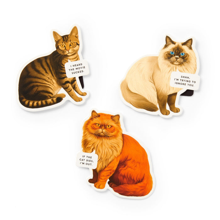 The Brass Monkey Moody Cats Magnetic Bookmark Set features three illustrated cats with witty signs: “I heard the movie sucked,” “Shhh. I’m trying to ignore you,” and “If the cat dies, I’m out.” A perfect gift for cat lovers!.