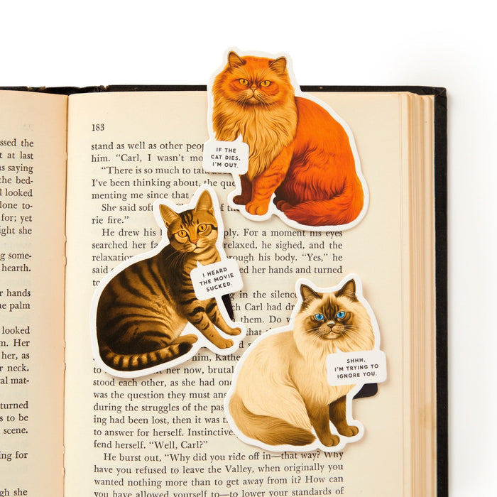 The Brass Monkey Moody Cats Magnetic Bookmark Set features three illustrated cat bookmarks with funny quotes: "If I fits, I sits," "I heard you suck at reading," and "Shhh, I'm trying to ignore you." Perfect for any reader!.