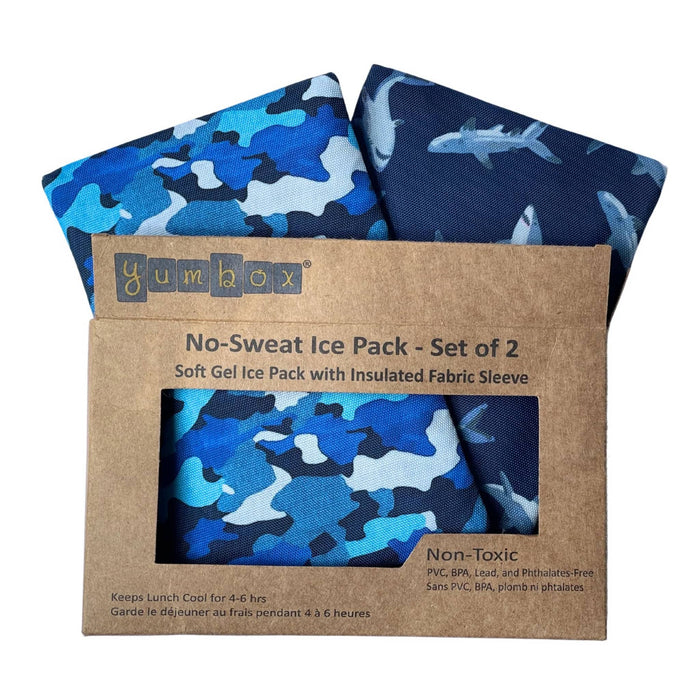 Two soft gel ice packs with fabric sleeves, one with a blue camouflage print and the other with a shark print, partially tucked inside a brown cardboard box on a plain white background.