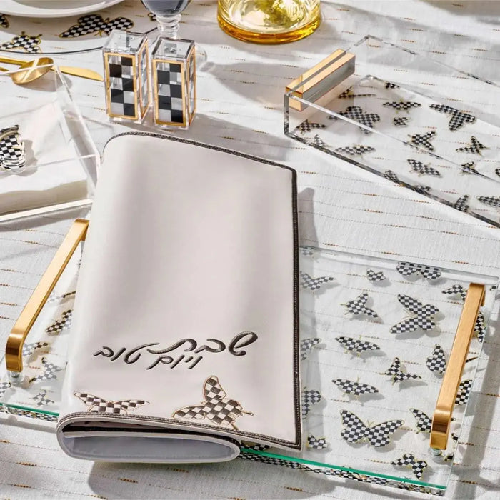 Onyx Butterfly Challah Board by Waterdale Collection displayed on white surface with Shabbat table settings and gold accents