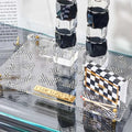 Onyx Butterfly Hadlokas Neiros Set with black and white checkered candlestick holders and matching square bases displayed on glass shelf.