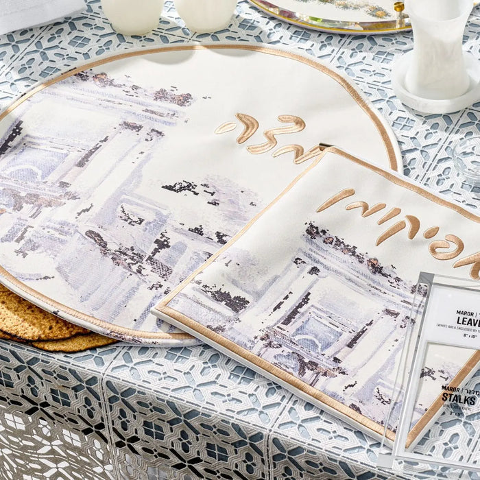 Painted Bais Hamikdash Pesach set with gold and white leather components displayed on Passover table with printed materials and ceremonial items.