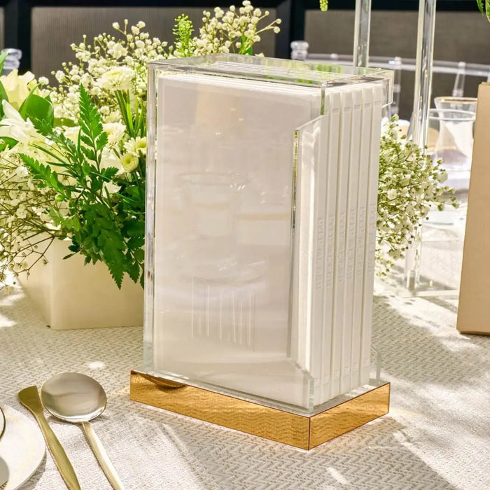 Cream and gold Painted Shabbos Zemiros Bencher Set displayed on wooden base with place settings and greenery in bright natural light