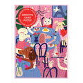 Colorful cats and dogs gather around a flower-adorned table on a pink and purple background in the completed Anne Bentley Paws for Love Greeting Card Puzzle.