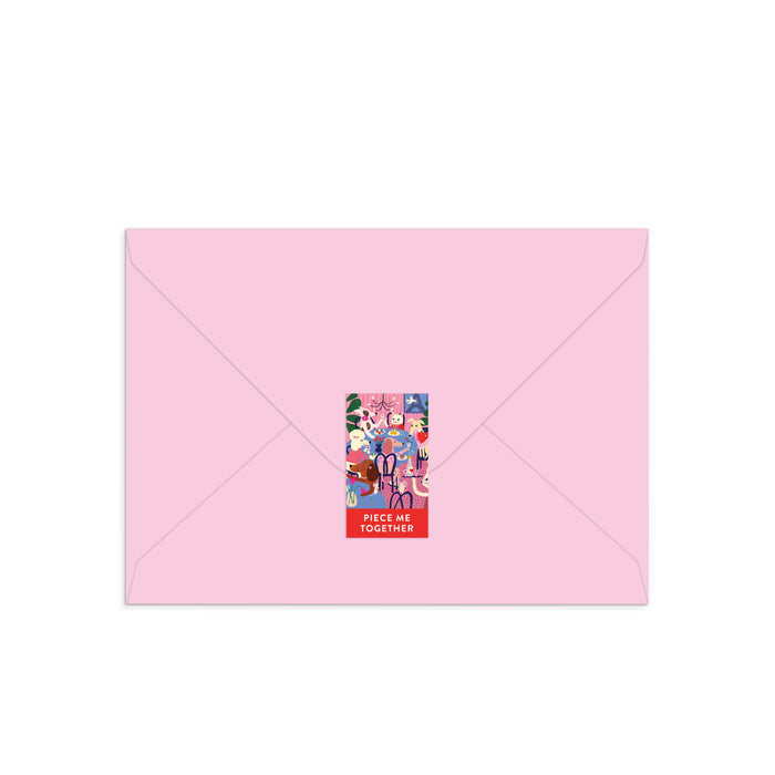 A light pink envelope sealed with a colorful rectangular sticker inspired by Anne Bentley’s Paws for Love Greeting Card Puzzle, featuring cartoon animals, people, and “PIECE ME TOGETHER” in bold white letters at the bottom.