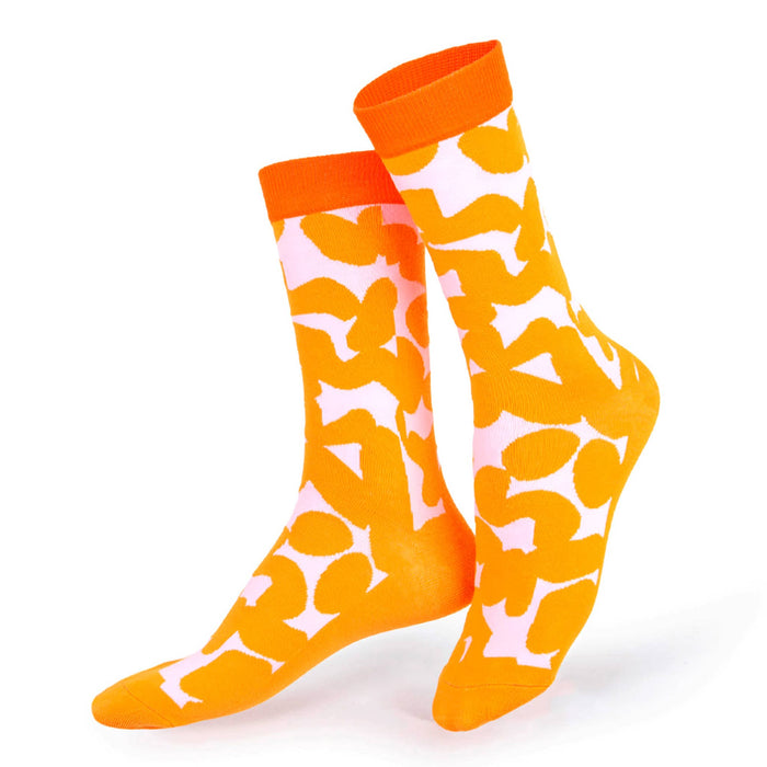 Orange socks with a pale pink abstract pattern on a white background.