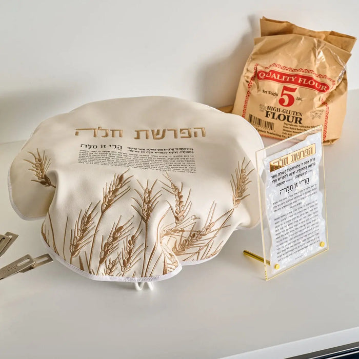 Pearlstone Hafrashas Challah tabletop plaque in gray and gold marble with Hebrew text, displayed next to matzah box on white surface.