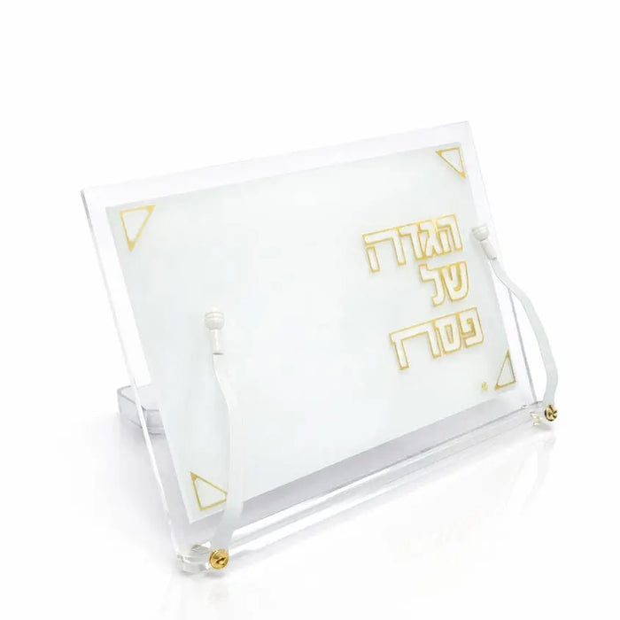 Pearlstone Haggadah stand with clear lucite frame and white pearl marble base, displaying gold text for Passover table.