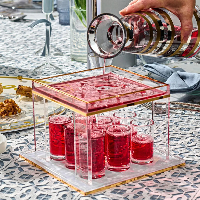 Pearl marble Kiddush fountain with red glass cups and matching tray, elegant Shabbat wine server for Jewish ceremonies and holiday gatherings.