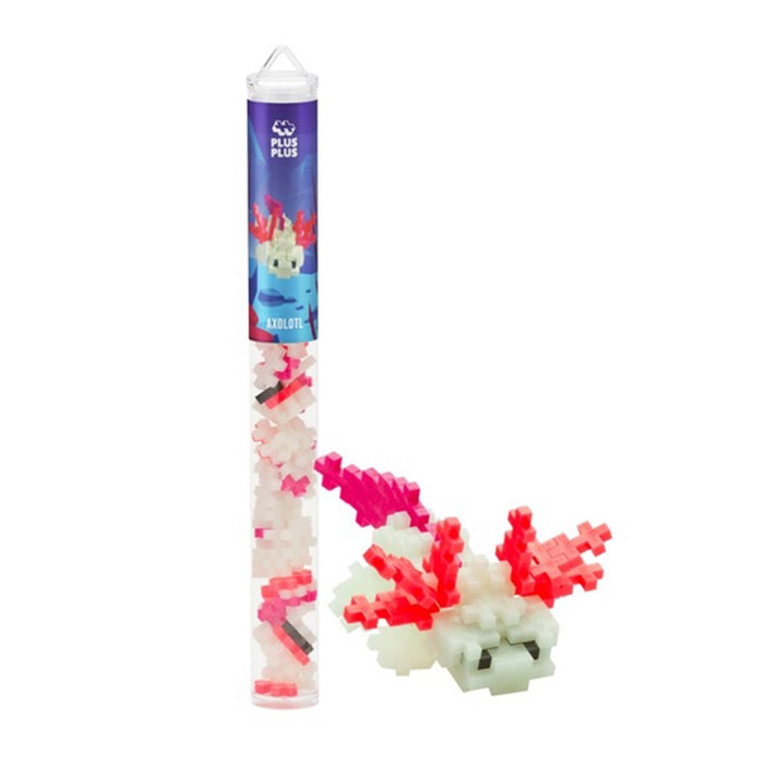 A tube of Plus Plus building blocks in white, red, pink, and black, coral pieces with a finished axolotl figure beside it, on a white background.