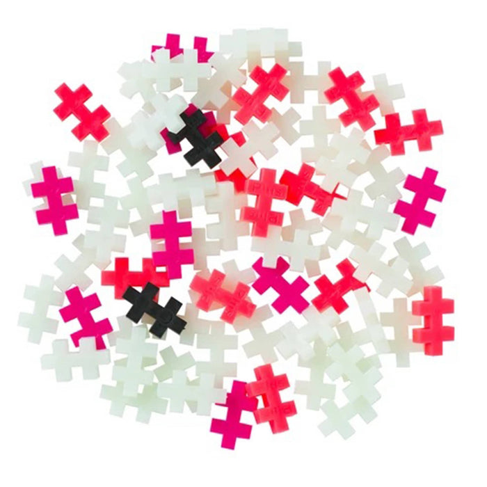 White, red, pink, and black plastic building blocks on a white background.