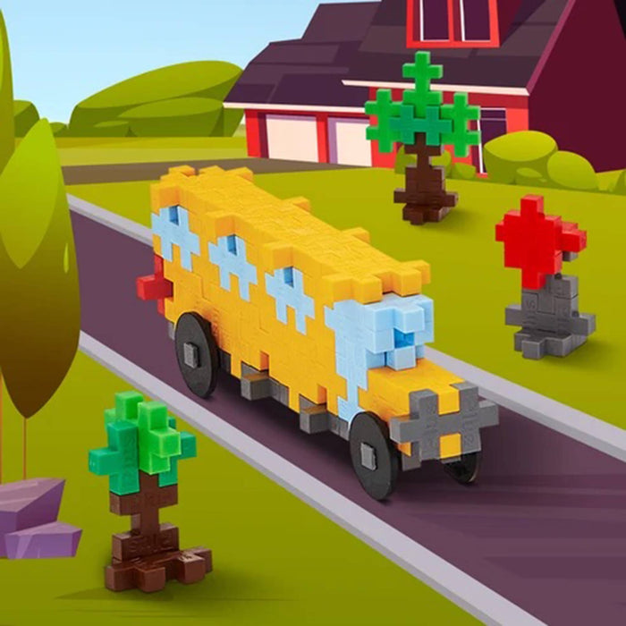 Toy school bus on a road with a house and trees in the background.