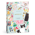 The Christine De Carvalho Purrfect Accessories Premium A5 Notebook features a colorful cover with cats, makeup, perfume bottles, and accessories on light blue, plus 300 lined premium pages.