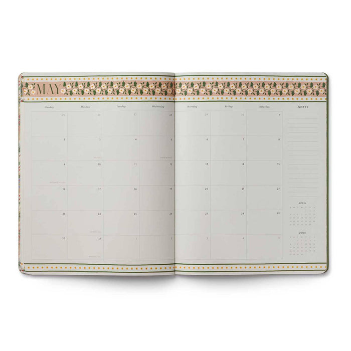 An open monthly calendar planner showing the month of May 2027, featuring a decorative beige and gold floral border on the top, set against a plain white background.