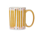 A white ceramic mug featuring a printed pattern of yellow pencils on lined paper, with a shiny gold handle and rim.