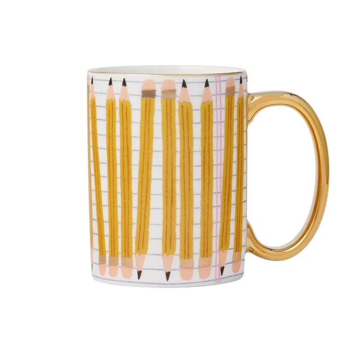 A white ceramic mug featuring a printed pattern of yellow pencils on lined paper, with a shiny gold handle and rim.