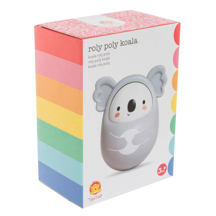 Roly Poly Koala toy packaging box featuring a gray koala on a white box with pastel rainbow side stripes and a pink patterned top, on a plain white background.