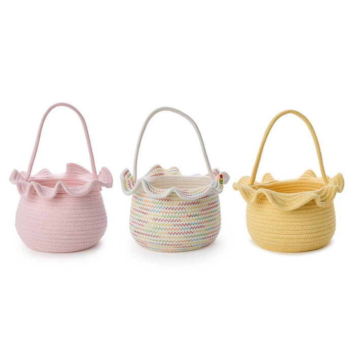 A pastel pink, white and yellow woven cotton rope baskets with ruffled edges on a white background.