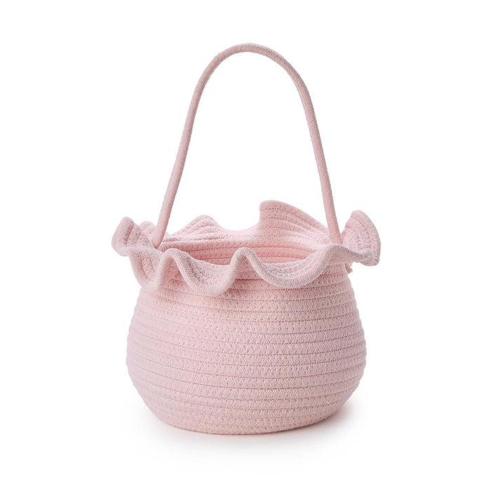 Pink woven basket with a ruffled top and handle on a white background.