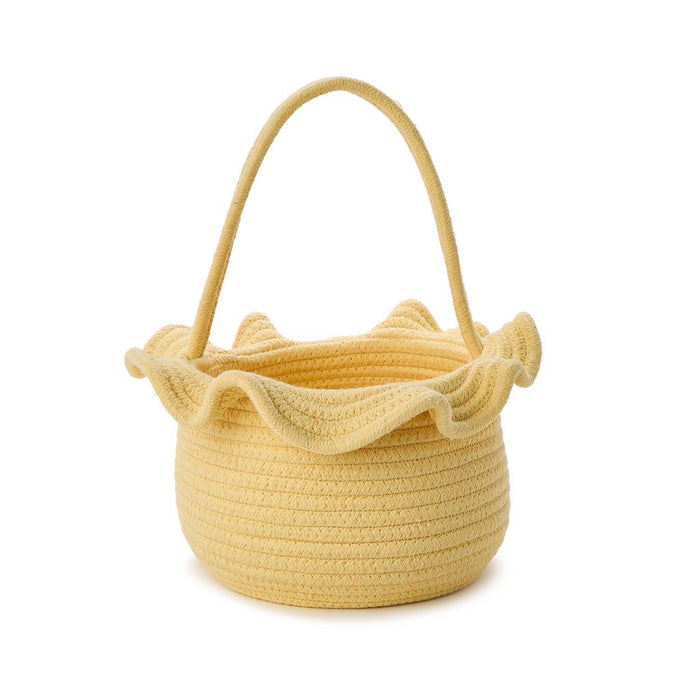 Yellow woven basket with a ruffled top and handle on a white background.