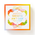 A vibrant box from Brass Monkey labeled Shrimpin Aint Easy Origami Kit features rainbow shrimp graphics and includes fun googly eyes for each folded shrimp creation.