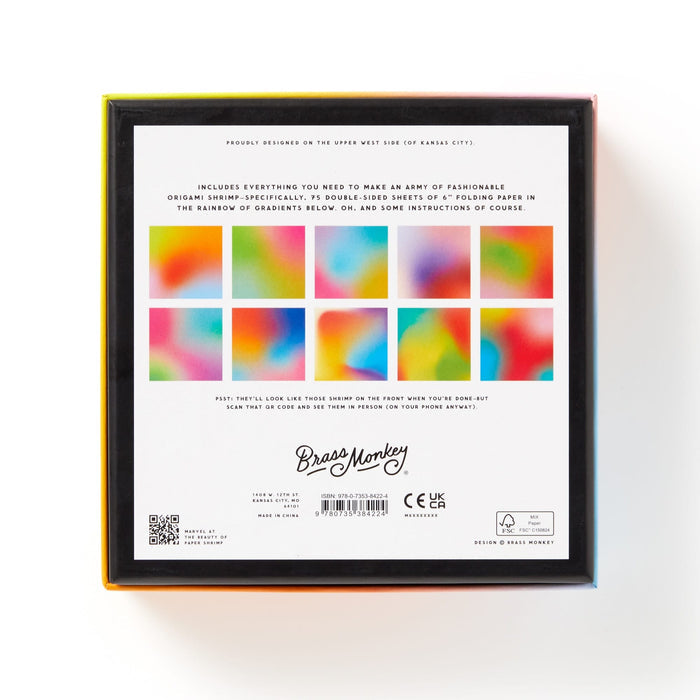 The image shows the back of a boxed Shrimpin Aint Easy Origami Kit by Brass Monkey, featuring twelve colorful gradient squares, kit contents described in text, and Brass Monkey branding at the bottom.
