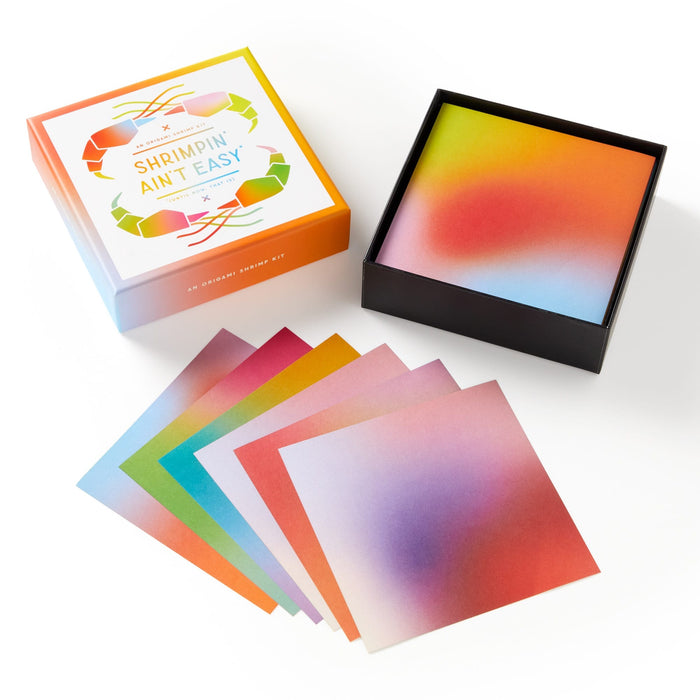 The Shrimpin Aint Easy Origami Kit by Brass Monkey features colorful gradient square cards, a black box and lid, and fun googly eyes—perfect for adding playful flair to your next origami project.