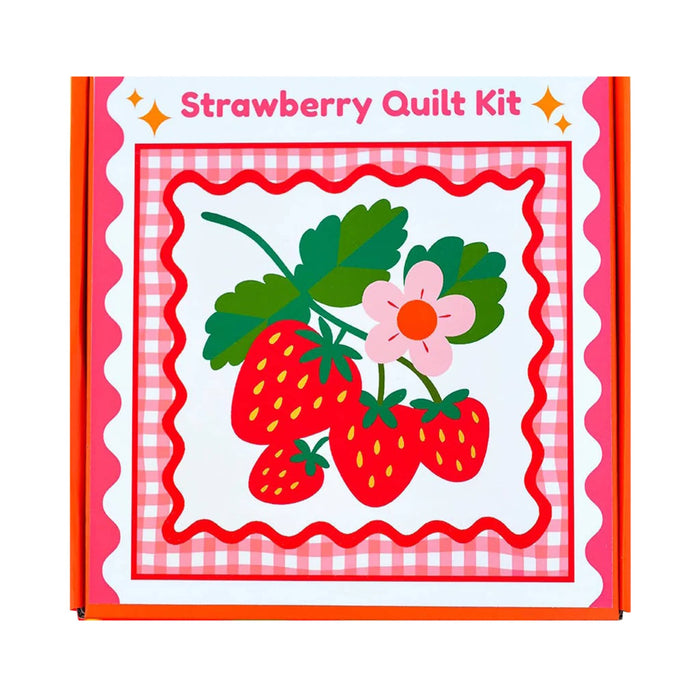 Strawberry quilt kit in box packaging with red strawberries and a flower, on a white background.