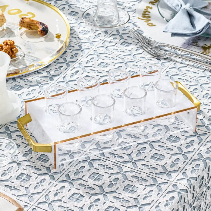 Suspended Pearlstone Liquor Set with white marble tray, gold metal frame, and drinking glasses arranged on patterned tablecloth for Shabbat entertaining.