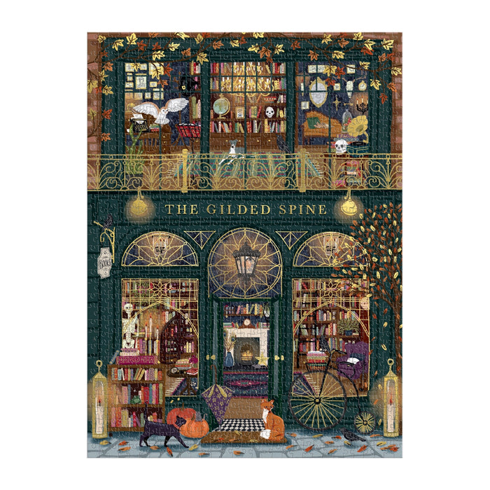 Sally Wilson’s The Gilded Spine 1000 Piece Foil Puzzle features a cozy two-floor bookshop filled with books, glowing lights, autumn leaves, and lounging cats in a warm, inviting scene with golden foil accents and intricate details.