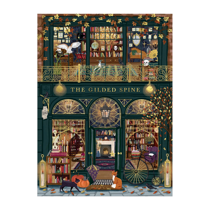 Experience Sally Wilson’s The Gilded Spine 1000 Piece Foil Puzzle, featuring a whimsical bookstore with two book-filled floors, arched windows, golden accents, fall leaves, and cozy autumn vibes—plus charming cats outside.