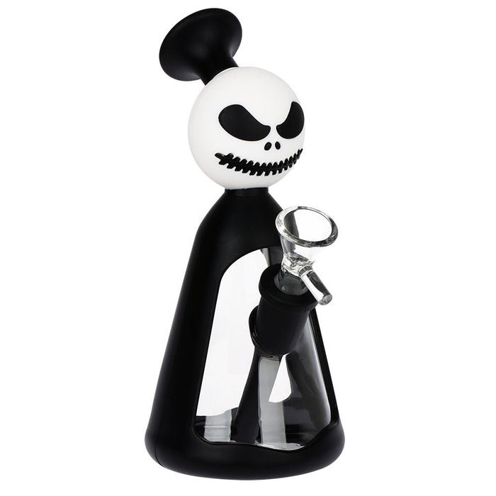 A novelty glass water pipe shaped like a stylized character with a white skull head, black hair, and a black body, holding a clear glass bowl. The product is shown on a solid white background.