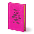 The Brass Monkey Tiny Diary for Not So Tiny Secrets is a small, bright pink hardbound diary with its name in black on the cover and features lined, gold-edged pages inside.
