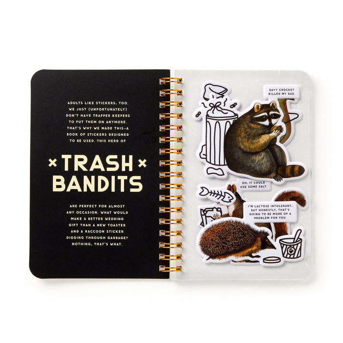 An open Brass Monkey Trash Bandits Sticker Book with puffy stickers. The left page has info about trash animal stickers, while the right features a raccoon, hedgehog, paw print, spilled drink, and trash can with funny speech bubbles.