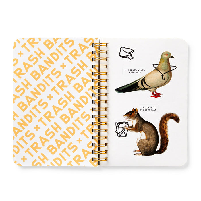 An open spiral notebook displays "TRASH BANDITS" in orange on the left page. On the right, a whimsical pigeon and squirrel with trash, like Brass Monkey's Trash Bandits Sticker Book animal characters, are featured.