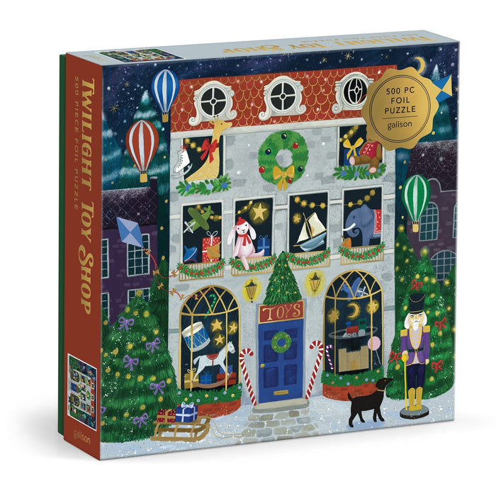 The Twilight Toy Shop 500 Piece Foil Puzzle by Bex Parkin features a festive toy shop scene with wreaths, lights, hot air balloons, a black cat, and a toy soldier outside.