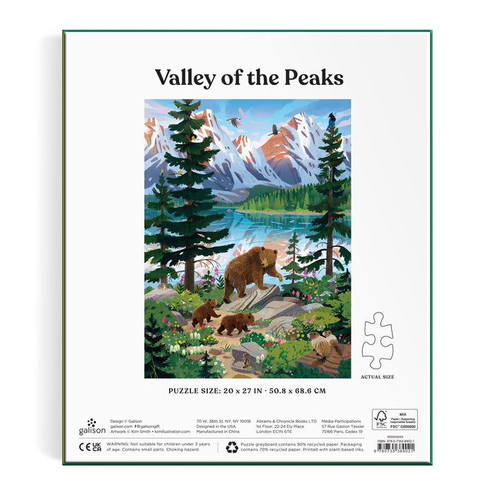 Illustration of snow-capped peaks, pine trees, a lake, bears, cubs, and birds. Text: "Valley of the Peaks." Below: Kim Smith Valley of the Peaks 1000 Piece Puzzle. Puzzle piece and size info appear underneath.