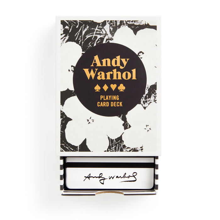 A deck of playing cards by the Andy Warhol Foundation for the Visual Arts, featuring black and white floral art, gold Warhol Pop Art Playing Card Deck text, premium cardstock, and Warhol’s signature inside the drawer box.