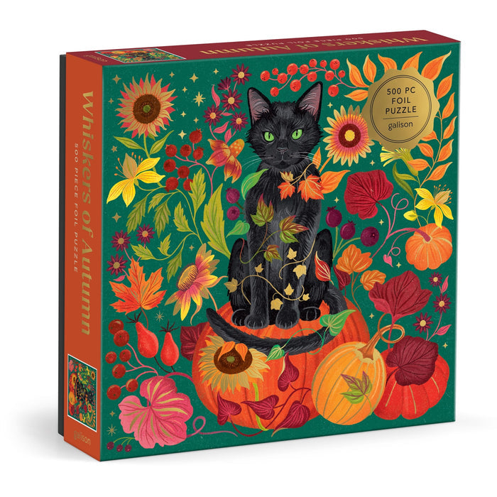 The Dawn Cooper Whiskers of Autumn 500 Piece Foil Puzzle features a black cat amid vibrant autumn leaves, pumpkins, flowers, and berries on a green background.