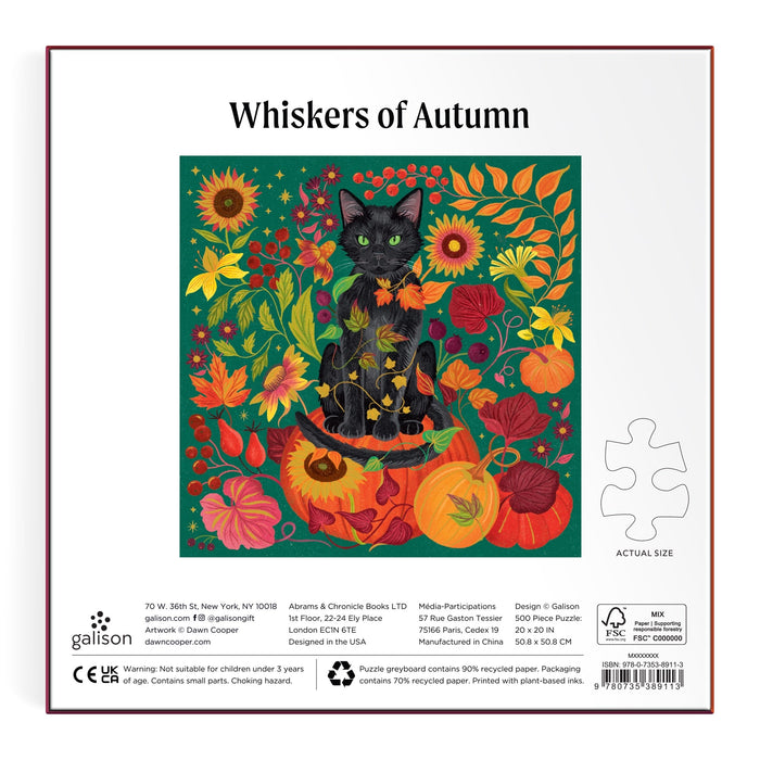 The Dawn Cooper Whiskers of Autumn 500 Piece Foil Puzzle box features a black cat among autumn flowers, leaves, and pumpkins on a green background, plus an image of a sample puzzle piece.