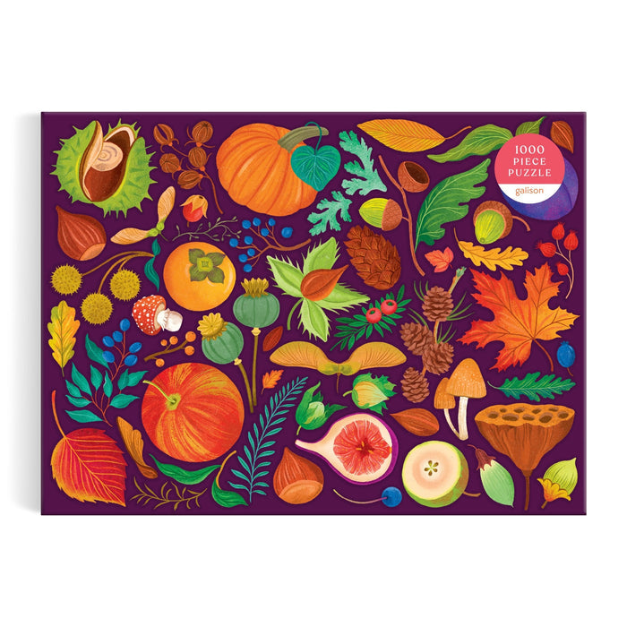 The World of Fall Flora 1000 Piece Puzzle by Dawn Cooper features a vibrant autumn design with illustrated pumpkins, mushrooms, leaves, berries, pinecones, acorns, and more on a dark purple box.