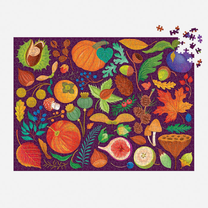 The World of Fall Flora 1000 Piece Puzzle by Dawn Cooper features autumn fruits, leaves, nuts, mushrooms, and foliage on a purple background, with a few pieces missing in the upper right corner.